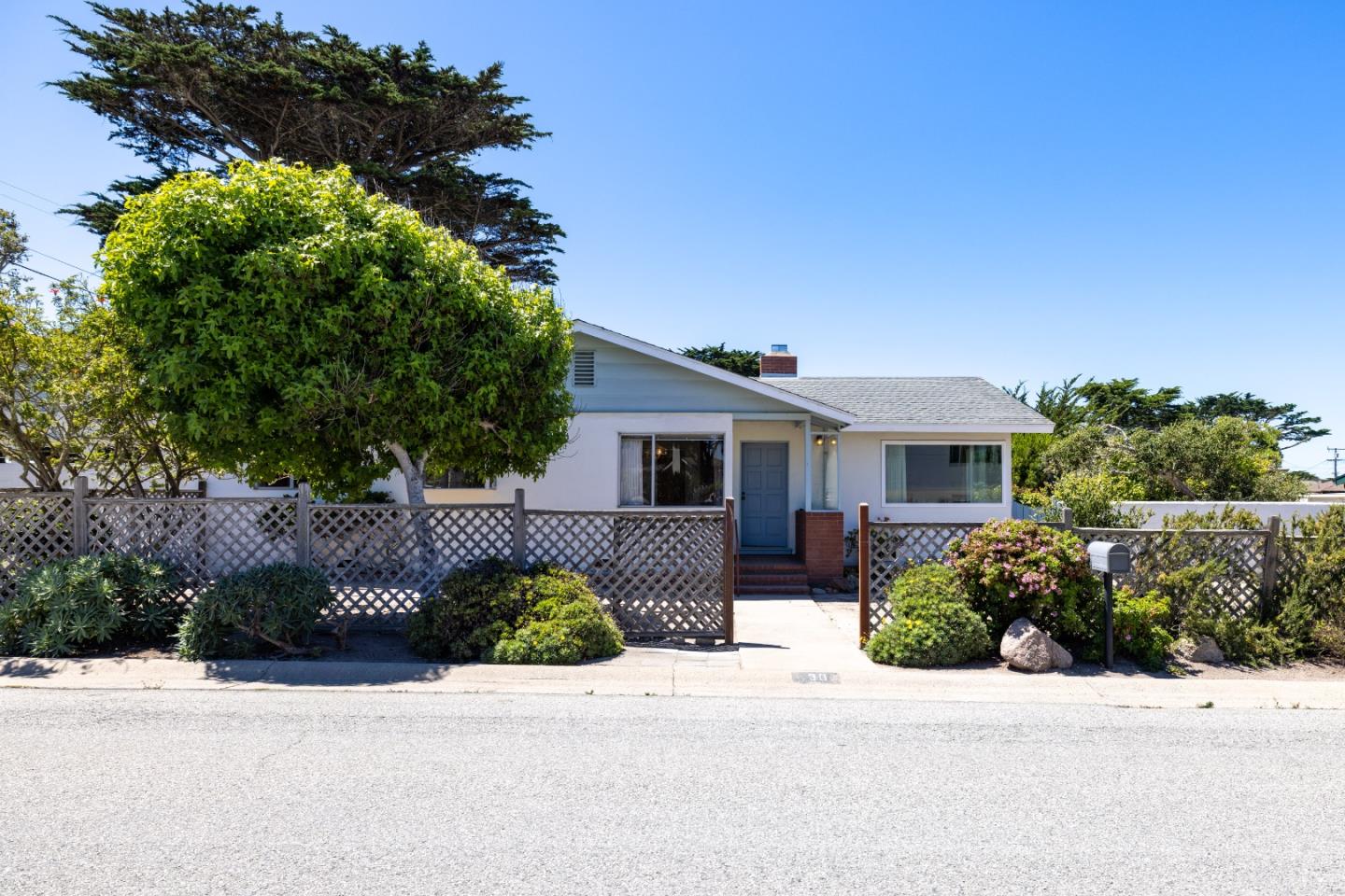 30 Acropolis Street Pacific Grove, CA 93950 - Photo 1 of 36 a front view of a house with a yard and a garage