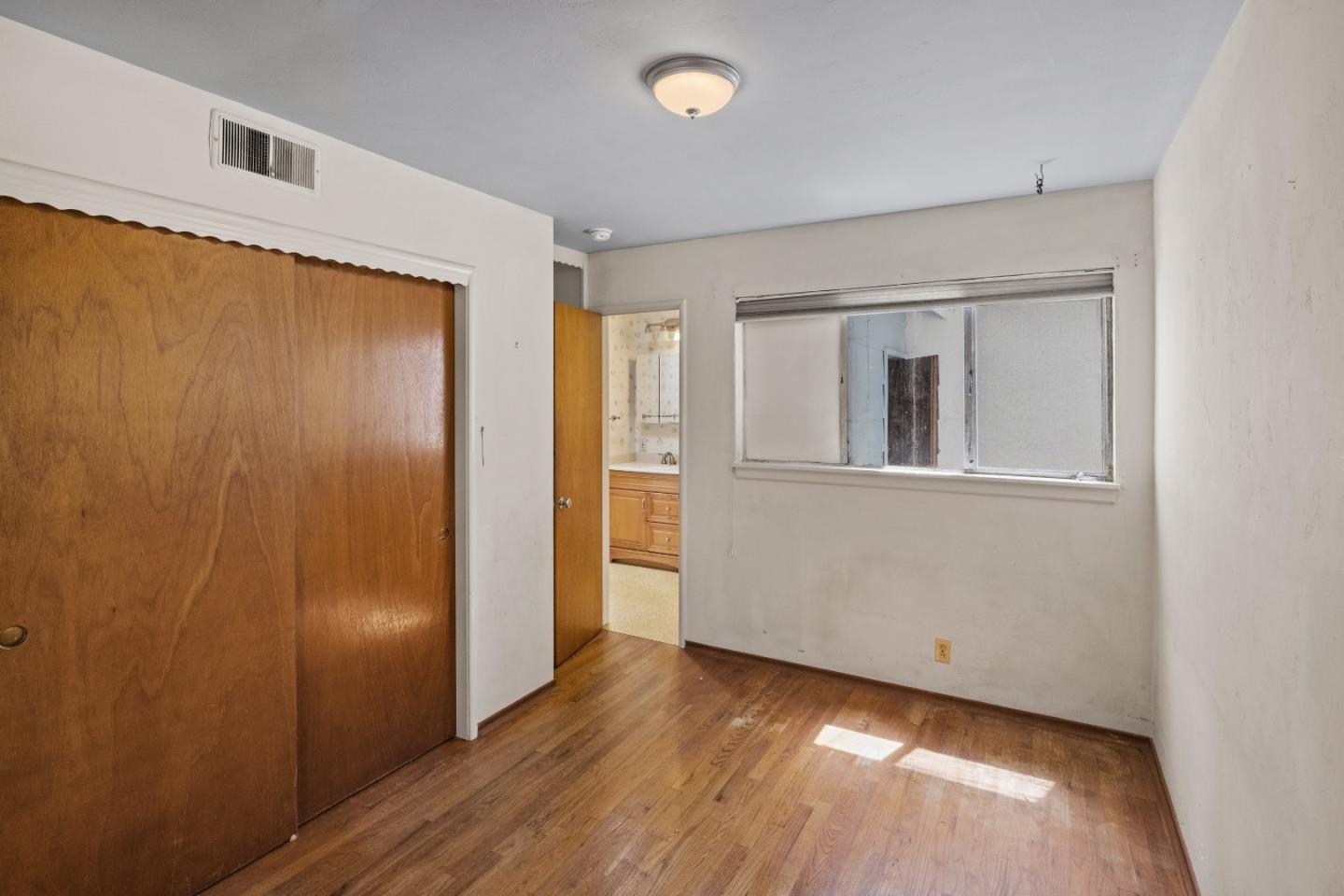 30 Acropolis Street Pacific Grove, CA 93950 - Photo 15 of 36 a view of an empty room with wooden floor and a window