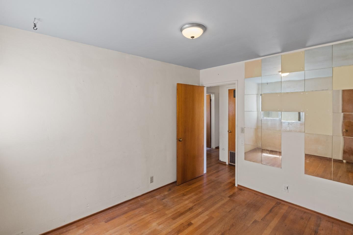 30 Acropolis Street Pacific Grove, CA 93950 - Photo 16 of 36 a view of an empty room with wooden floor and a bathroom