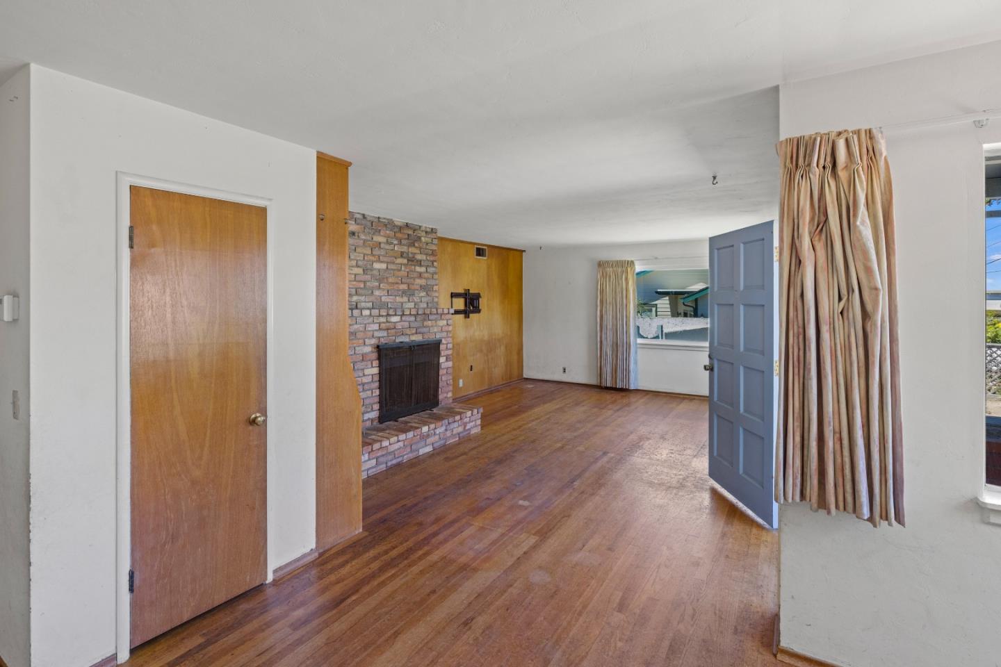 30 Acropolis Street Pacific Grove, CA 93950 - Photo 4 of 36 a view of a living room with a fireplace and wooden floor