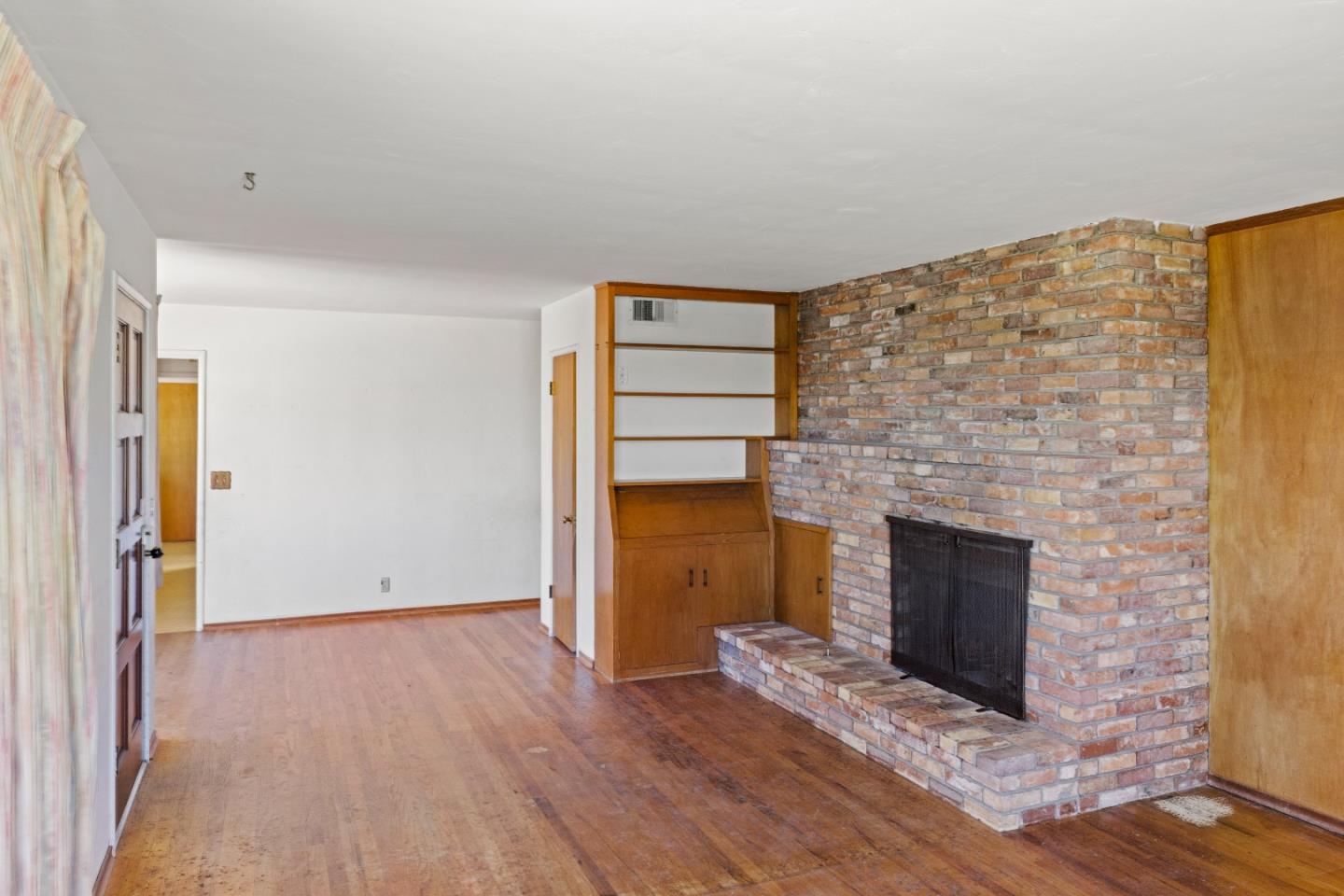 30 Acropolis Street Pacific Grove, CA 93950 - Photo 7 of 36 a view of empty room with wooden floor and fireplace