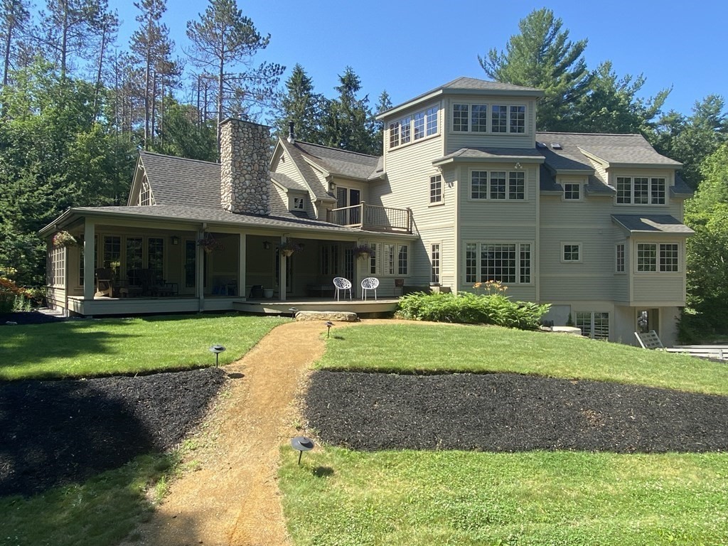 231 Turkey Hill Trail Rutland, MA 01543 - Photo 1 of 42 a front view of a house with a yard and trees