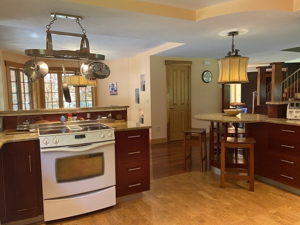 231 Turkey Hill Trail Rutland, MA 01543 - Photo 11 of 42 a kitchen with a stove and cabinets