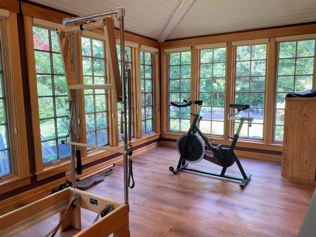 231 Turkey Hill Trail Rutland, MA 01543 - Photo 16 of 42 a living room filled with furniture and floor to ceiling windows