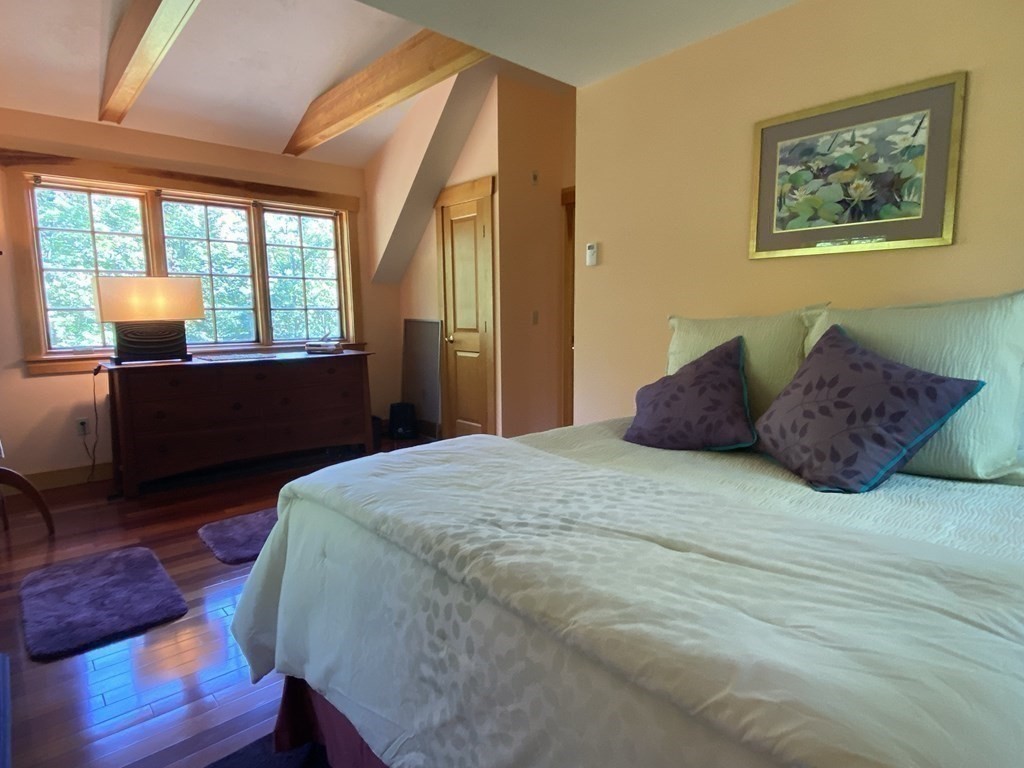 231 Turkey Hill Trail Rutland, MA 01543 - Photo 24 of 42 a bedroom with a bed and wooden floor