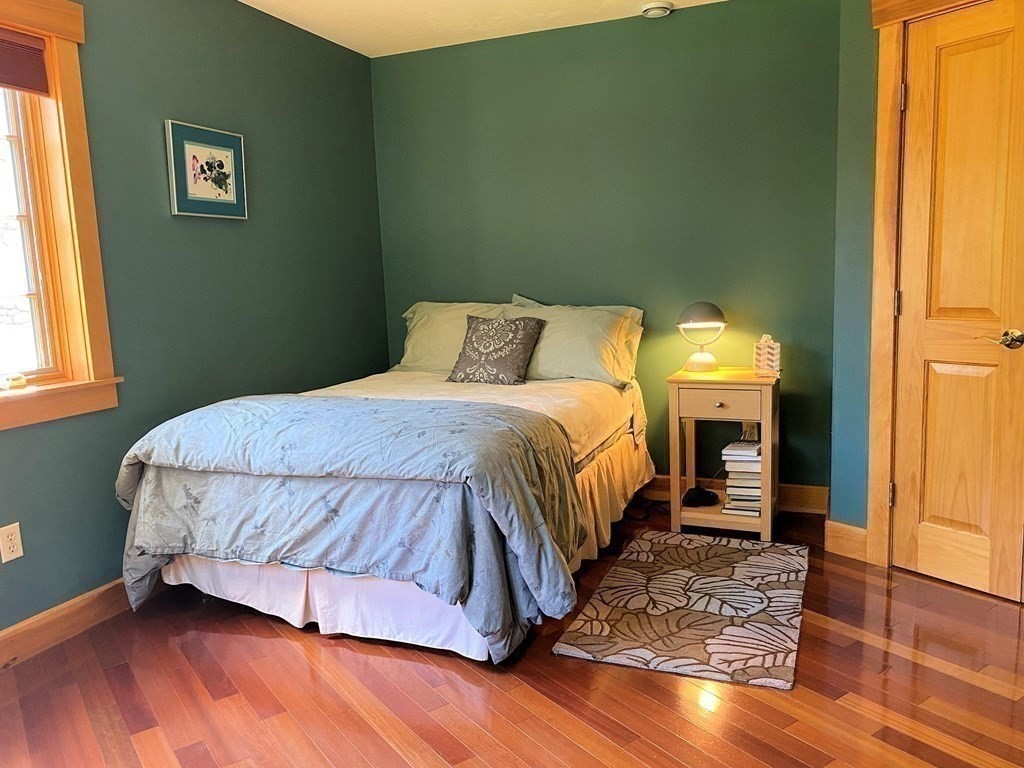 231 Turkey Hill Trail Rutland, MA 01543 - Photo 25 of 42 a bedroom with a bed and wooden floor