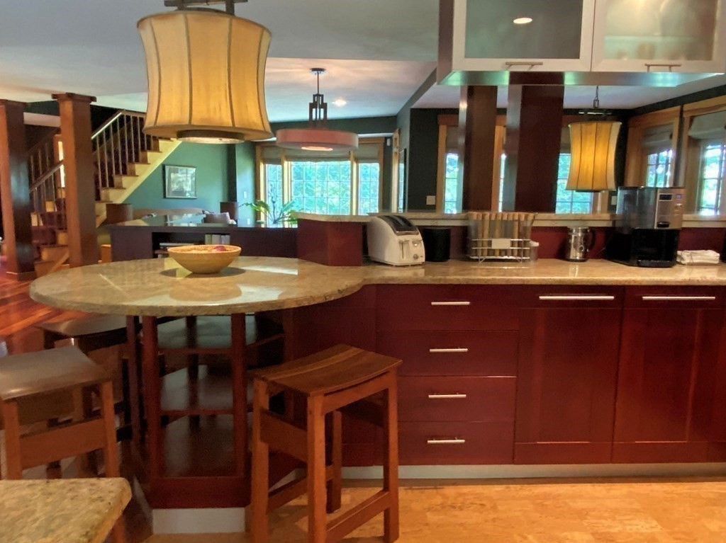 231 Turkey Hill Trail Rutland, MA 01543 - Photo 8 of 42 a kitchen with a sink a counter space and a dining table
