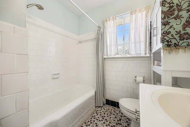 a bathroom with a sink toilet and bathtub