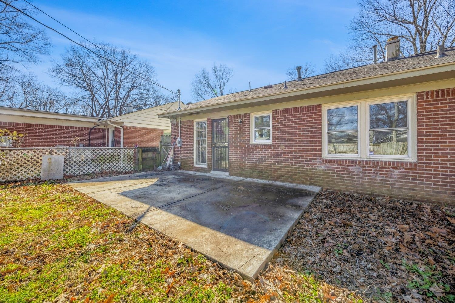 4490 Garnett Road Memphis, TN 38117 - Photo 18 of 18 Back of property with a patio area, brick siding, and a chimney