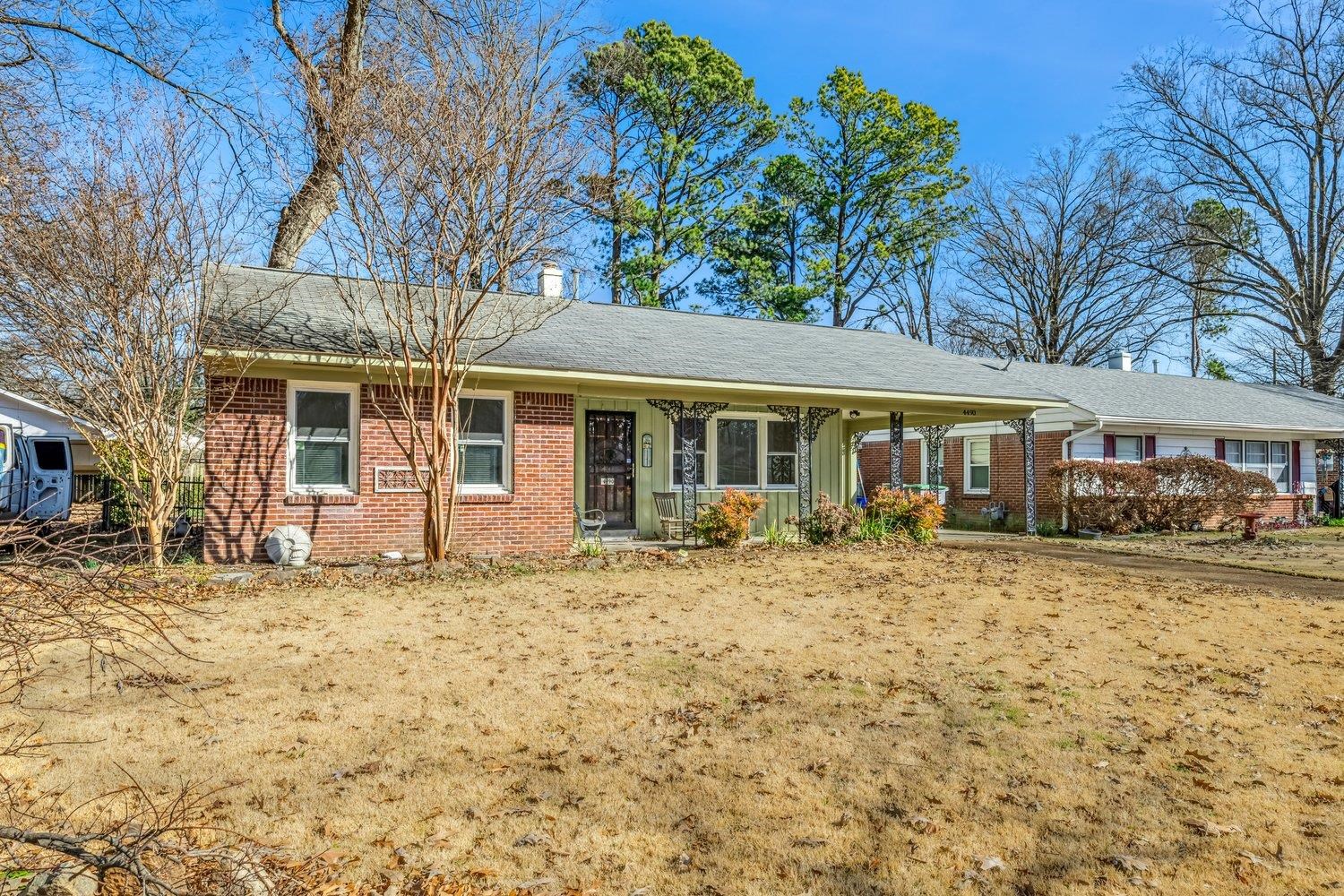 4490 Garnett Road Memphis, TN 38117 - Photo 2 of 18 Ranch-style house with brick siding, a chimney, a porch, and roof with shingles