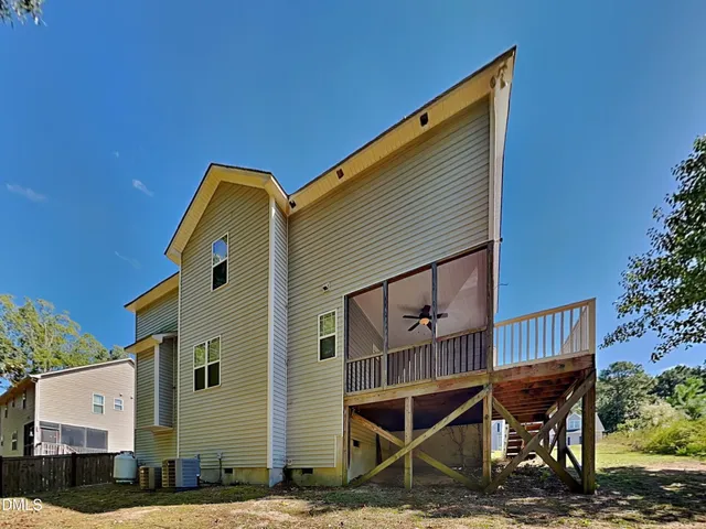 a backyard of a house with table and chairs
