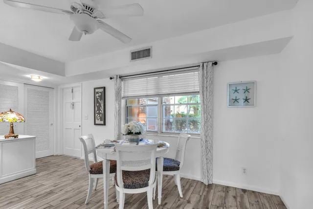 a view of a dining room with furniture and window