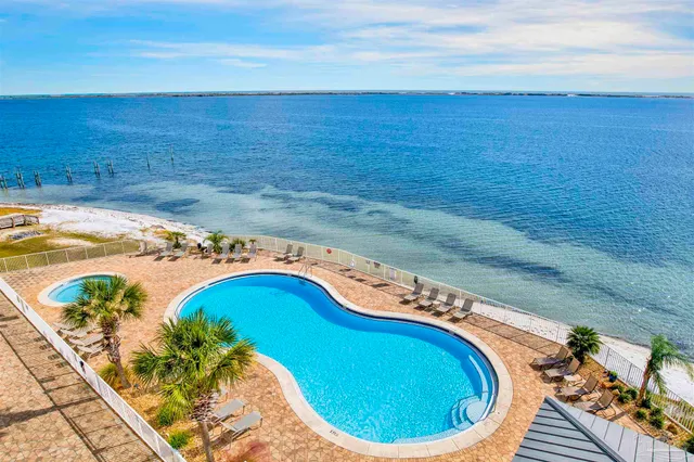 a kitchen with stainless steel appliances granite countertop a sink and a refrigerator