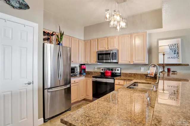 a bedroom with a bed a couch and a chandelier