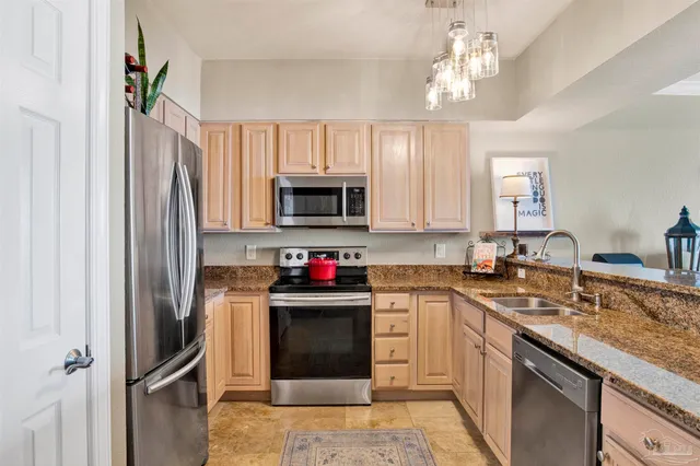 a bedroom with a bed and a flat tv screen on dresser