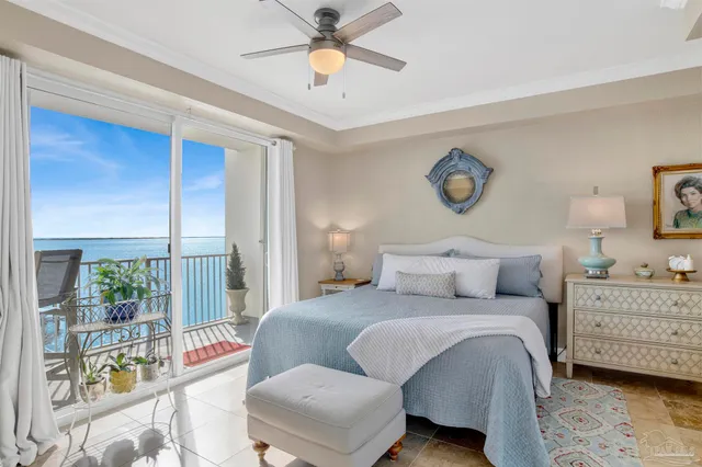a dining room with furniture and a floor to ceiling window