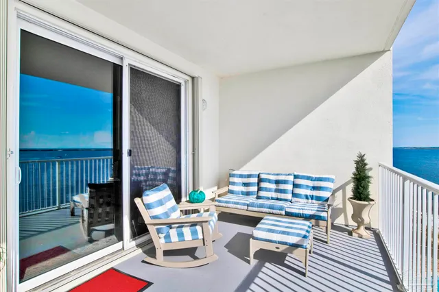 a view of balcony with wooden floor and seating space
