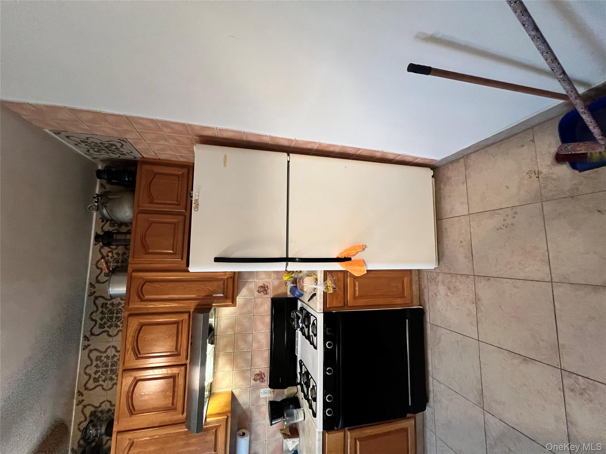 829 Southern Boulevard, Unit 3D Bronx, NY 10459 - Photo 1 of 11 a kitchen with granite countertop a refrigerator and a stove top oven