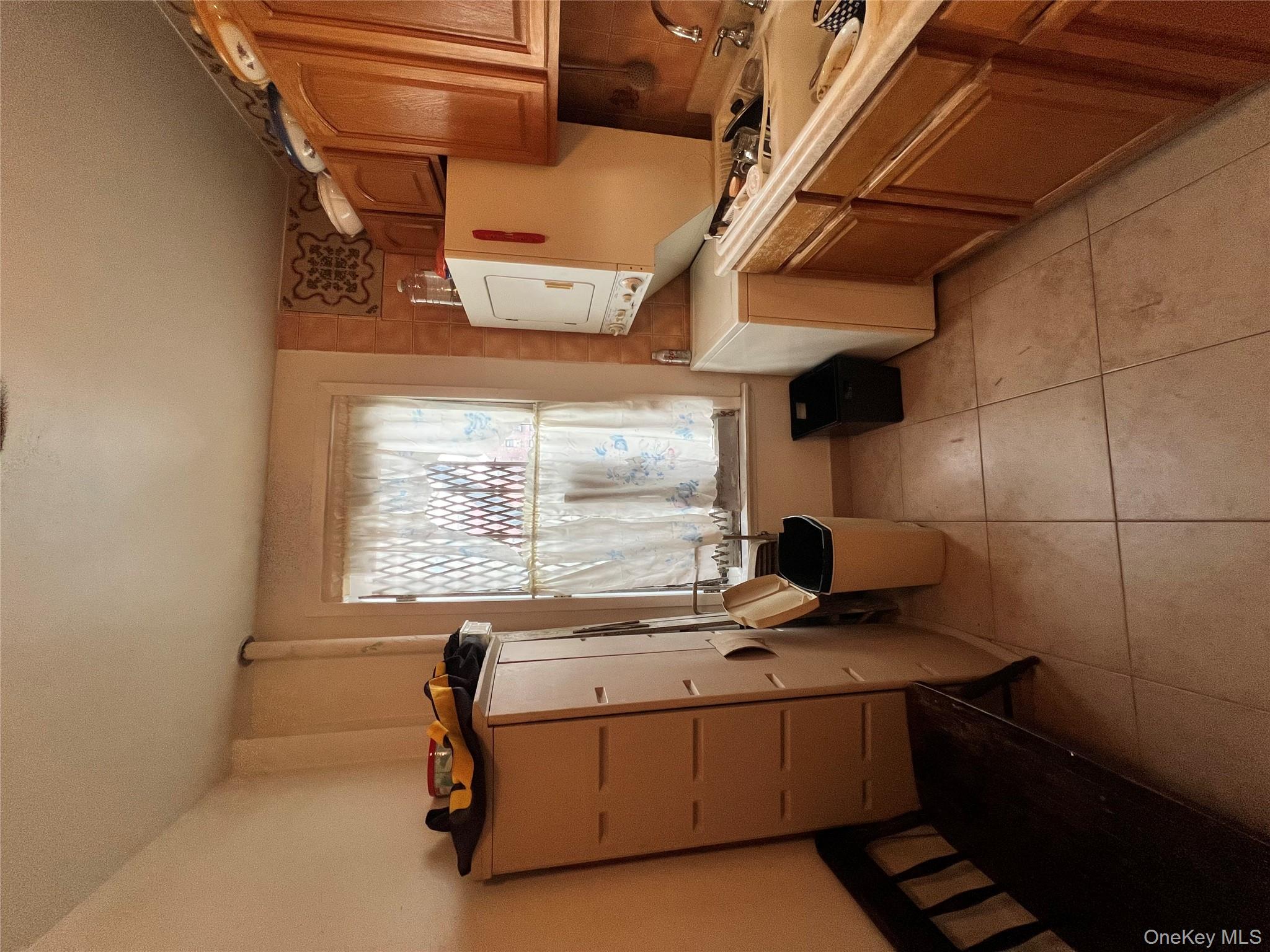 829 Southern Boulevard, Unit 3D Bronx, NY 10459 - Photo 2 of 11 a kitchen with a refrigerator and a stove