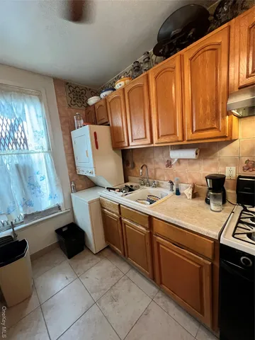 a kitchen with a sink cabinets and appliances
