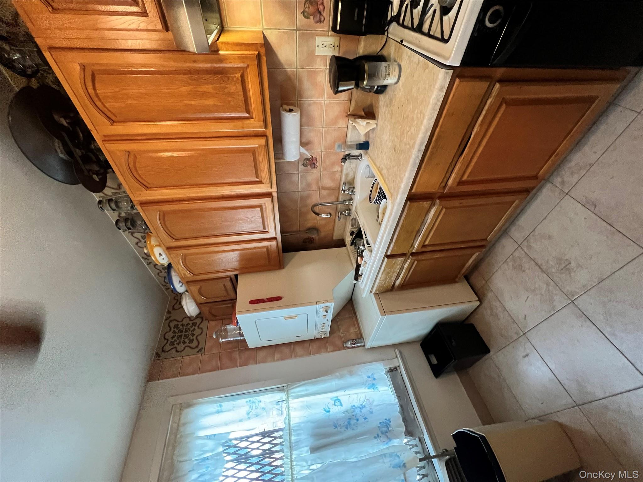 829 Southern Boulevard, Unit 3D Bronx, NY 10459 - Photo 3 of 11 a kitchen with a sink cabinets and appliances