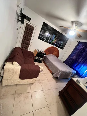 a bed room with a bed and a television