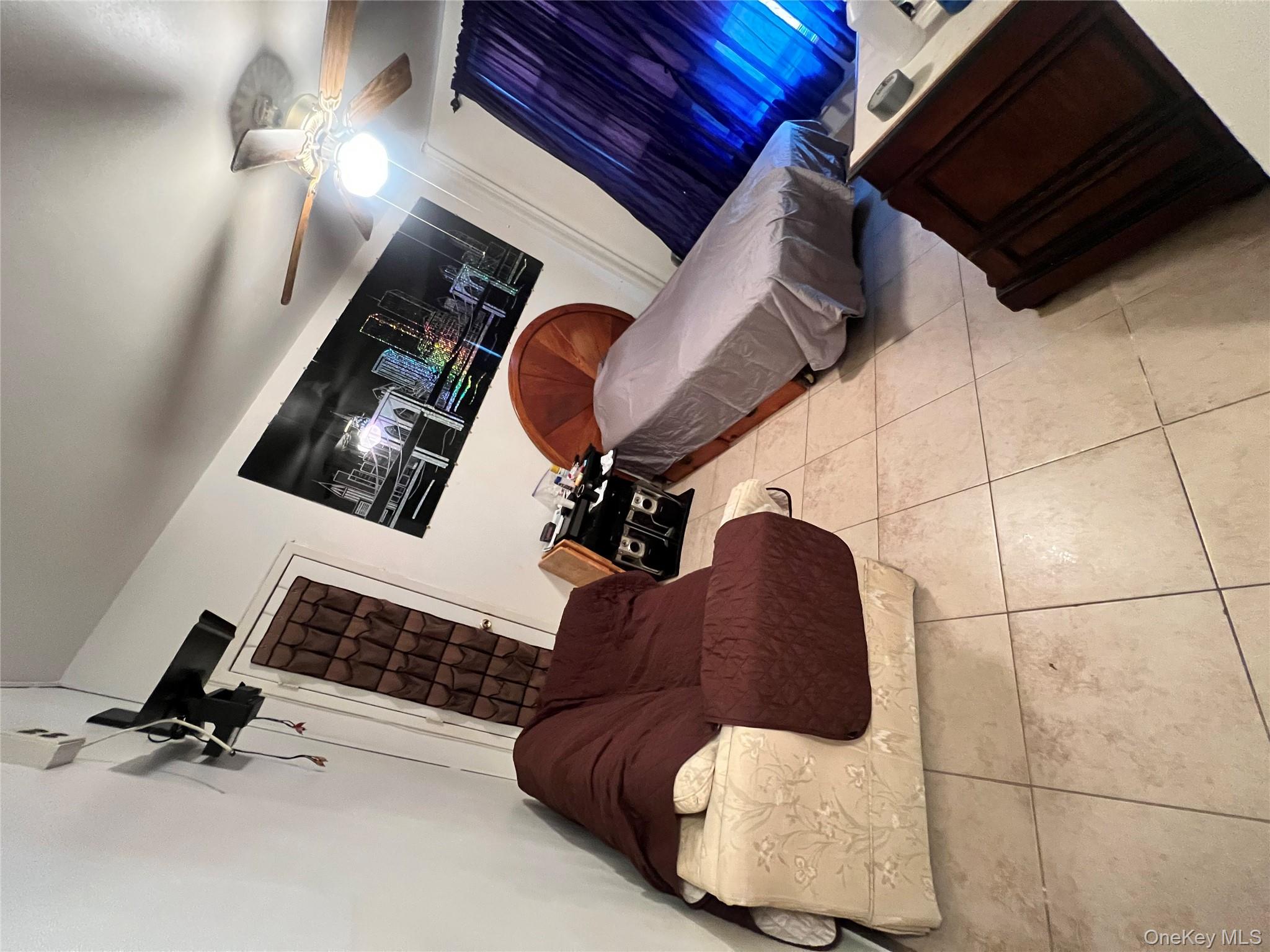 829 Southern Boulevard, Unit 3D Bronx, NY 10459 - Photo 5 of 11 a bed room with a bed and a television