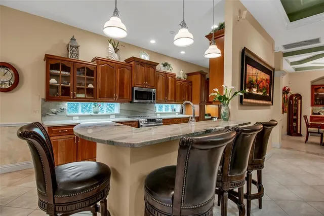 a bathroom with a granite countertop sink a mirror a vanity and bathtub
