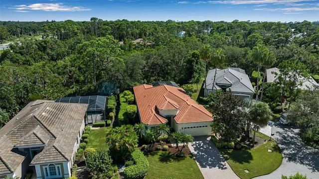 a view of a dining room with furniture and a chandelier