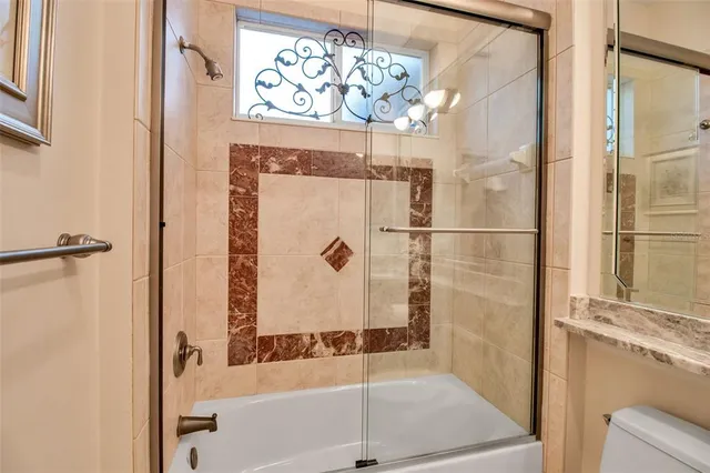 a living room with furniture and a floor to ceiling windows