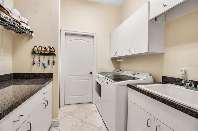 a living room with lots of furniture and chandelier