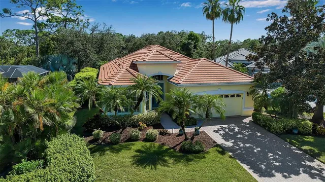 an aerial view of a residential houses with outdoor space and street view