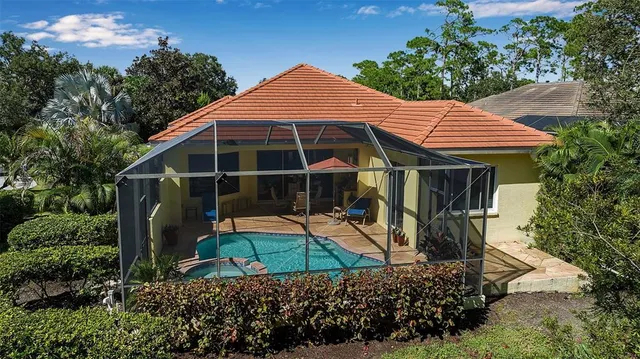 an aerial view of a house with outdoor space and lake view