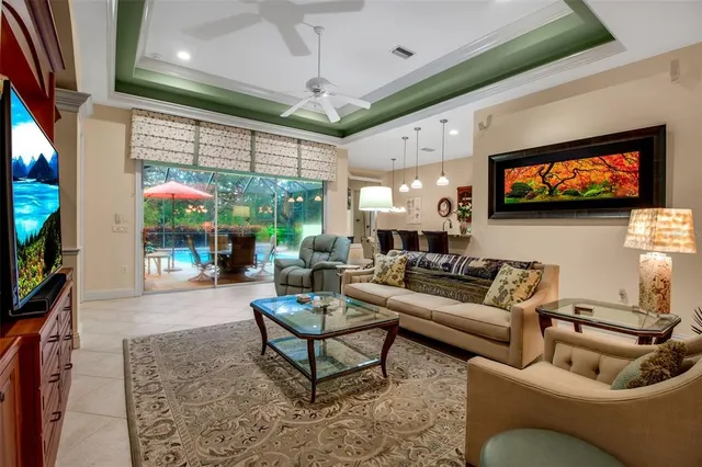 a dining room with furniture and a large window