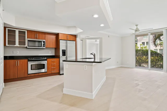 a view of a kitchen with a sink and a fireplace