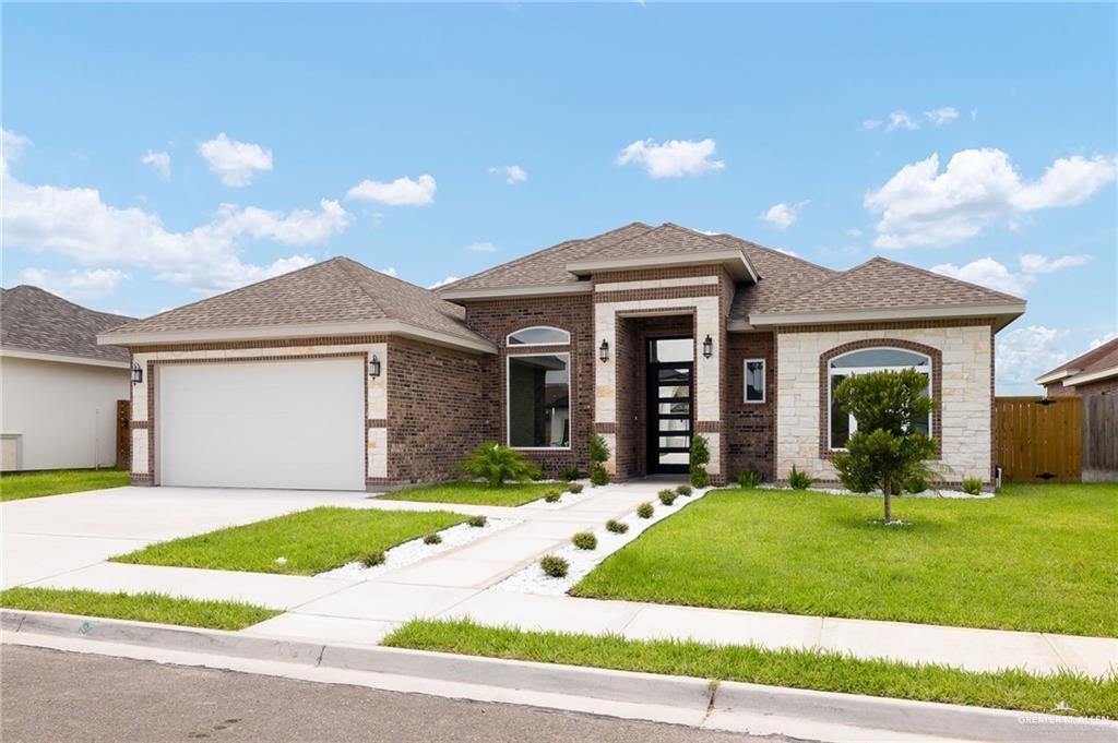 705 La Laguna Road Mission, TX 78572 - Photo 1 of 1 a front view of a house with a yard and garage
