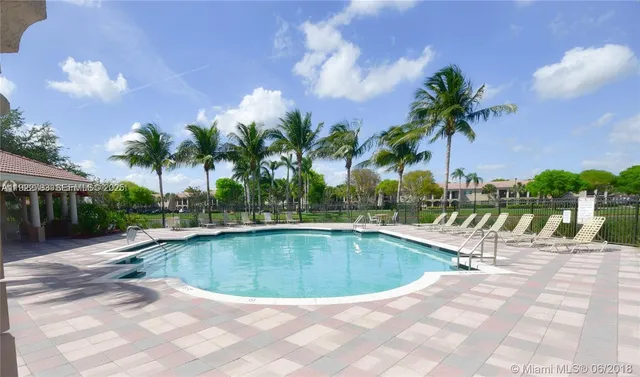 a view of a swimming pool with a lounge chair