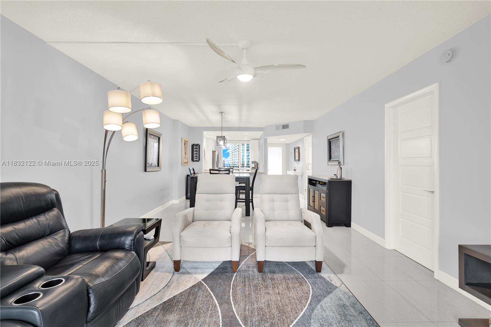521 North Riverside Drive, Unit 707 Pompano Beach, FL 33062 - Photo 15 of 50 a living room with furniture and a chandelier