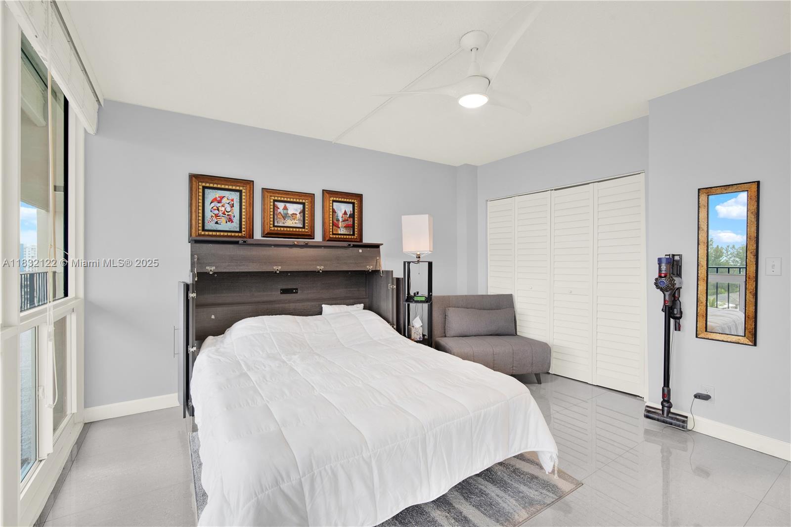 521 North Riverside Drive, Unit 707 Pompano Beach, FL 33062 - Photo 20 of 50 a bed room with a bed and a night stand