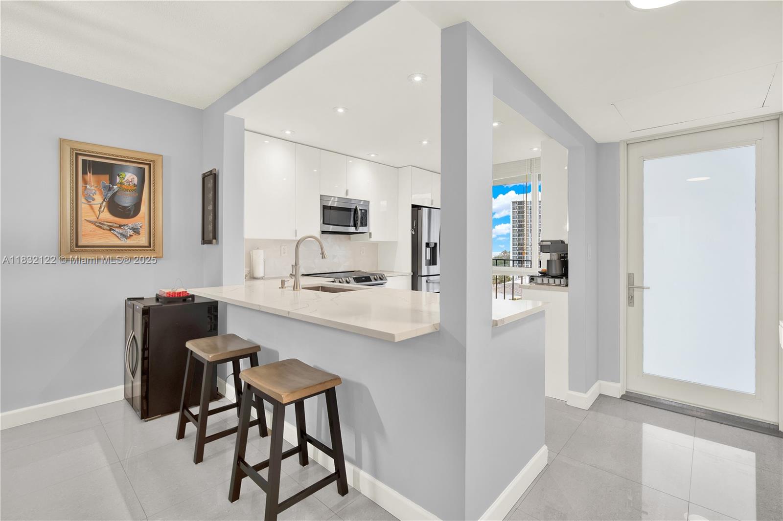 521 North Riverside Drive, Unit 707 Pompano Beach, FL 33062 - Photo 2 of 50 a kitchen with stainless steel appliances kitchen island granite countertop a refrigerator and a stove top oven