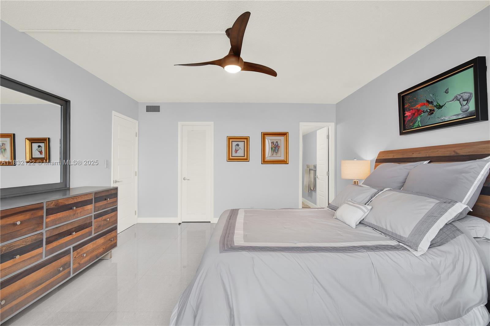 521 North Riverside Drive, Unit 707 Pompano Beach, FL 33062 - Photo 25 of 50 a bed room with a bed and a television