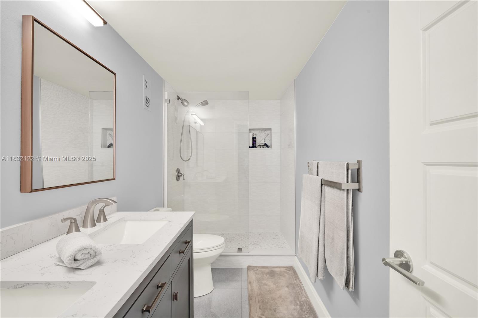 521 North Riverside Drive, Unit 707 Pompano Beach, FL 33062 - Photo 26 of 50 a bathroom with a sink a toilet and shower