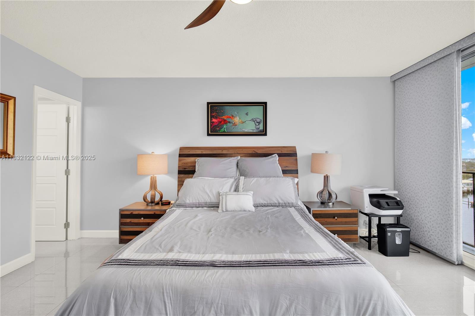 521 North Riverside Drive, Unit 707 Pompano Beach, FL 33062 - Photo 28 of 50 a bedroom with a bed and a lamp