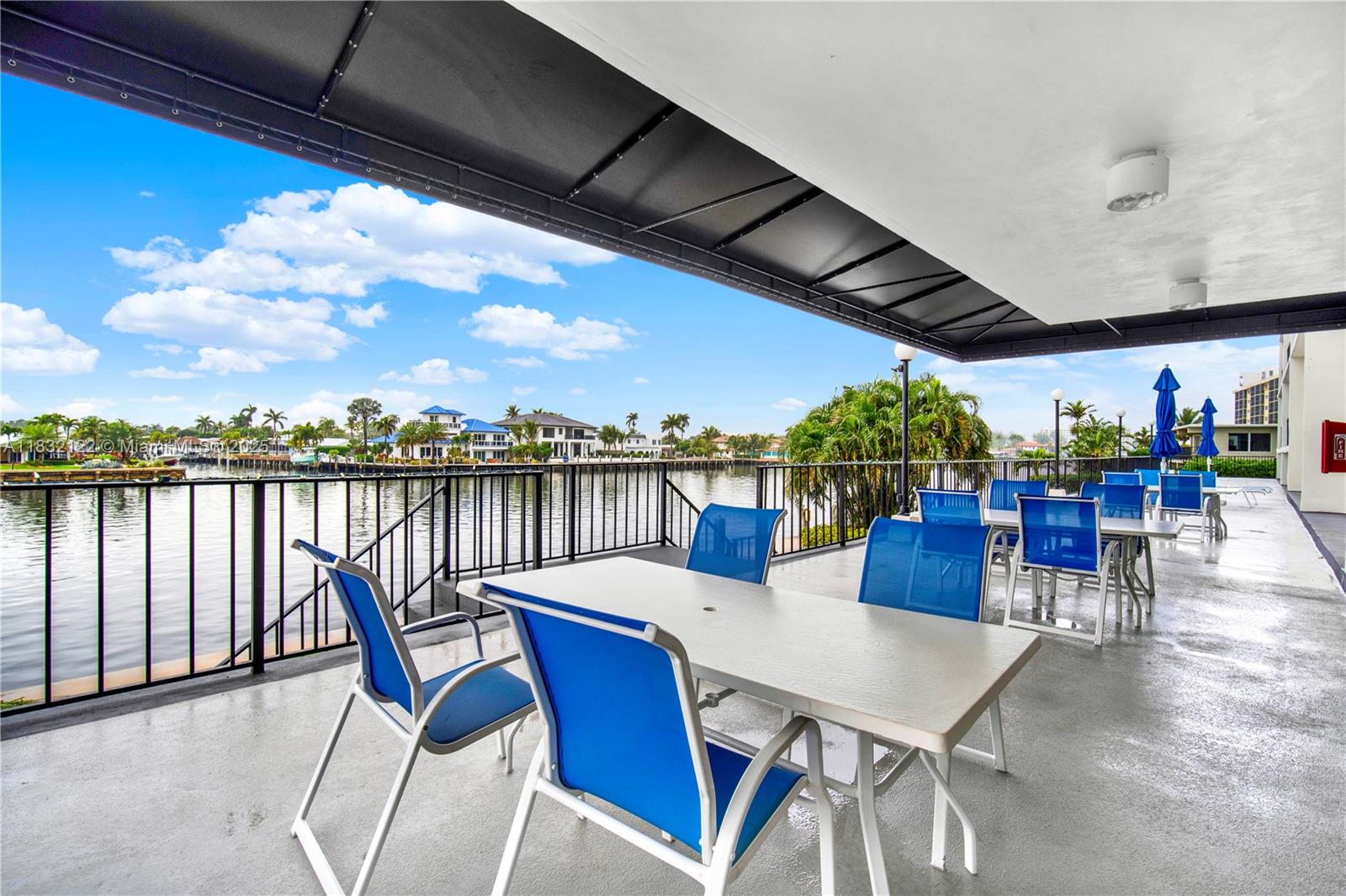 521 North Riverside Drive, Unit 707 Pompano Beach, FL 33062 - Photo 40 of 50 a view of a chairs and table on the terrace