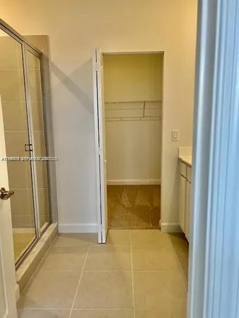 a bathroom with a glass shower door