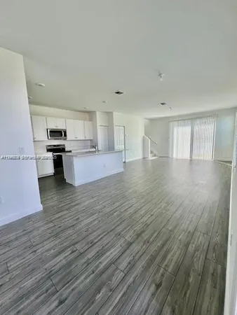 a view of a kitchen with microwave and cabinets