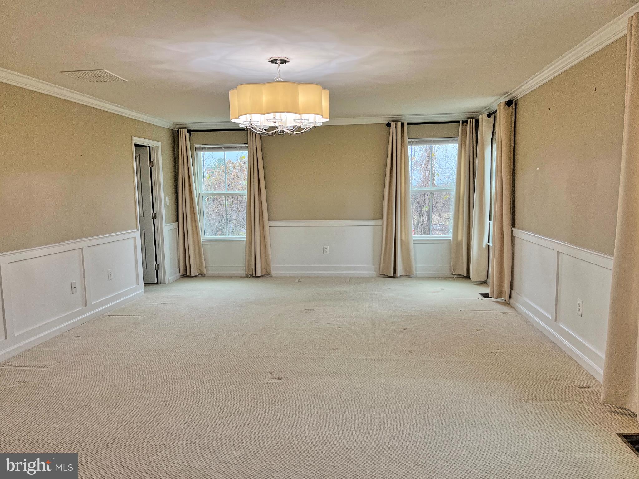 120 Standpipe Road Culpeper, VA 22701 - Photo 9 of 22 an empty room with a chandelier fan and a window