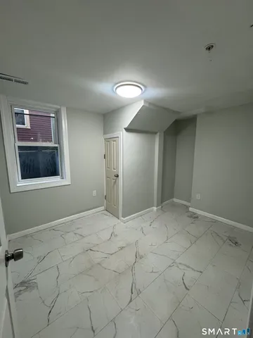 a white toilet sitting next to a bath tub