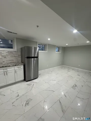 a kitchen with stainless steel appliances a refrigerator and a counter top space