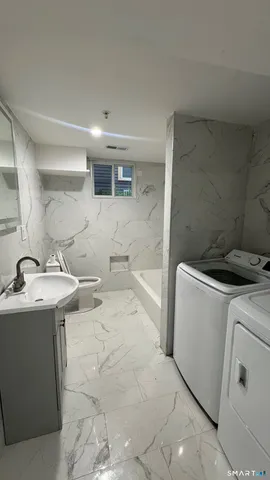 a bathroom with a sink toilet and tub
